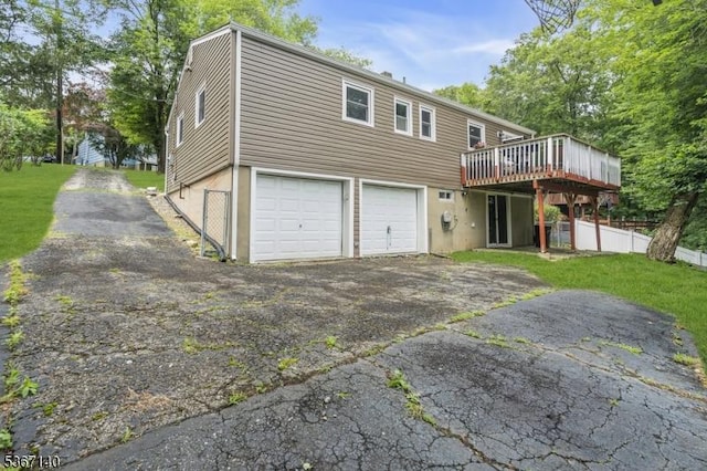 32 Mountain Heights Dr, Byram Twp, NJ 07871 - rear view of property with a wooden deck, asphalt driveway, and a garage