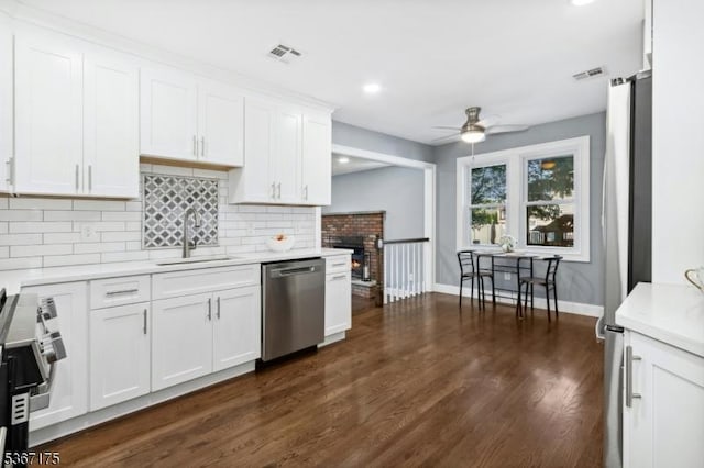 945 Wendy Ct, Union Twp, NJ 07083 - kitchen with stainless steel appliances, a ceiling fan, light countertops, decorative backsplash, and white cabinetry