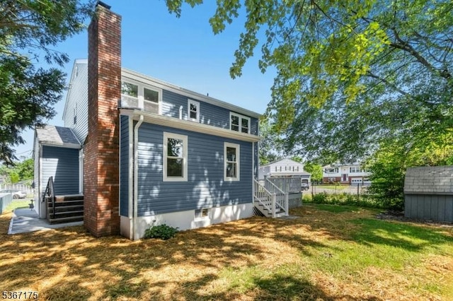 945 Wendy Ct, Union Twp, NJ 07083 - rear view of property with a chimney, stairway, and a storage shed
