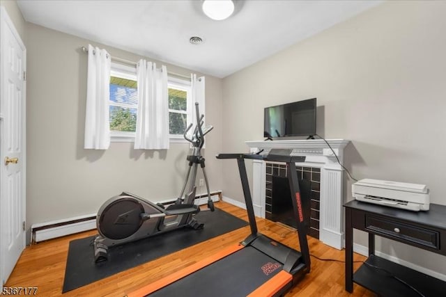 129 Francis St, Pohatcong Twp, NJ 08865 - workout room with a baseboard heating unit and wood finished floors