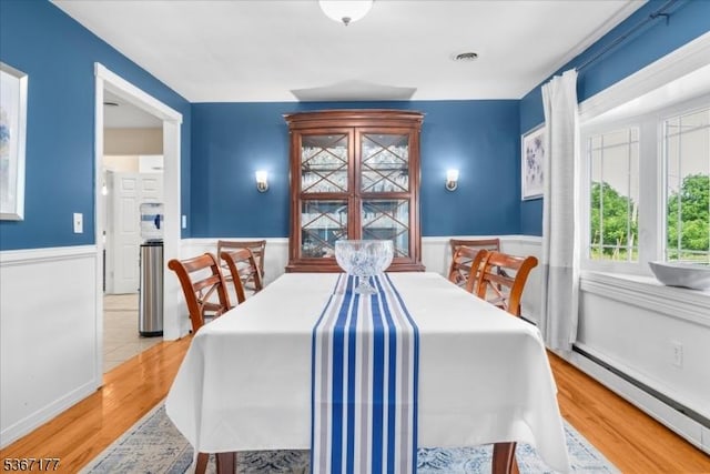 129 Francis St, Pohatcong Twp, NJ 08865 - dining room featuring wainscoting, wood finished floors, and a baseboard radiator
