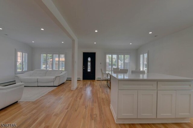 55 Florence St, Nutley Twp, NJ 07110 - kitchen with open floor plan, healthy amount of natural light, baseboard heating, white cabinets, and recessed lighting