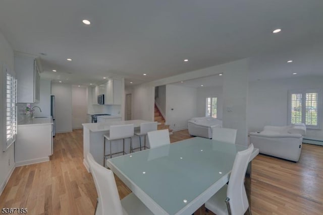 55 Florence St, Nutley Twp, NJ 07110 - dining area with stairway, light wood-style flooring, recessed lighting, and a baseboard heating unit