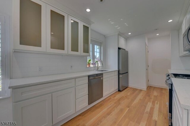 55 Florence St, Nutley Twp, NJ 07110 - kitchen featuring stainless steel appliances, white cabinets, tasteful backsplash, light wood-type flooring, and recessed lighting