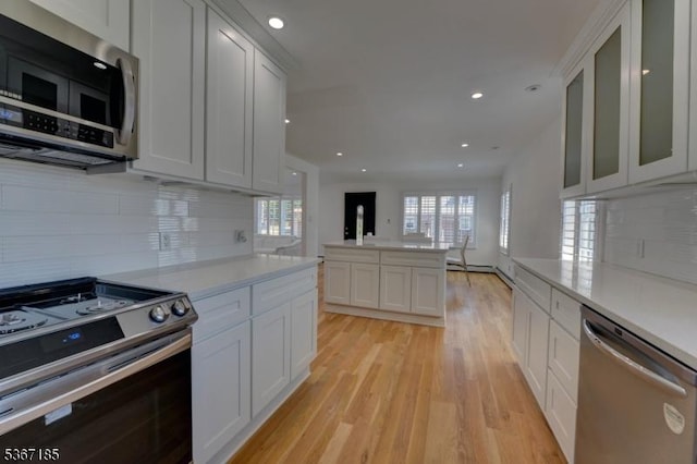 55 Florence St, Nutley Twp, NJ 07110 - kitchen featuring stainless steel appliances, plenty of natural light, light wood-type flooring, decorative backsplash, and recessed lighting