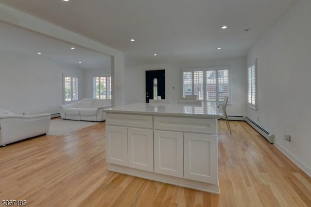 55 Florence St, Nutley Twp, NJ 07110 - kitchen with baseboard heating, white cabinetry, open floor plan, light wood-style flooring, and recessed lighting