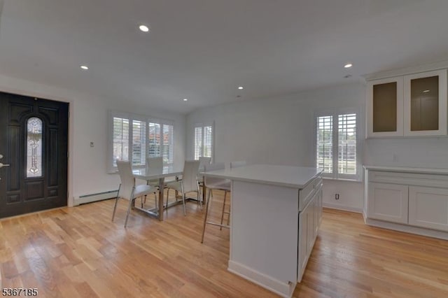 55 Florence St, Nutley Twp, NJ 07110 - kitchen with healthy amount of natural light, light countertops, light wood finished floors, a baseboard radiator, and recessed lighting