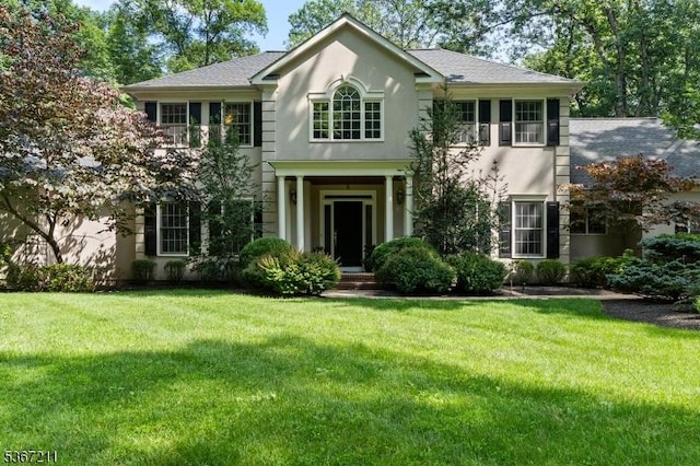 5 Mcvickers Ln, Mendham Twp, NJ 07945 - colonial home featuring a front yard, stucco siding, and a shingled roof