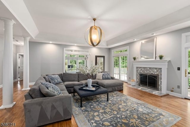 5 Mcvickers Ln, Mendham Twp, NJ 07945 - living room featuring a raised ceiling, decorative columns, wood finished floors, a stone fireplace, and recessed lighting
