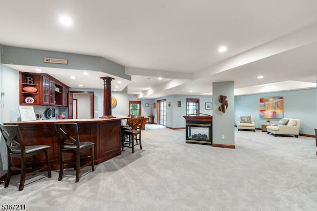 5 Mcvickers Ln, Mendham Twp, NJ 07945 - kitchen with open floor plan, light colored carpet, recessed lighting, a breakfast bar, and glass insert cabinets