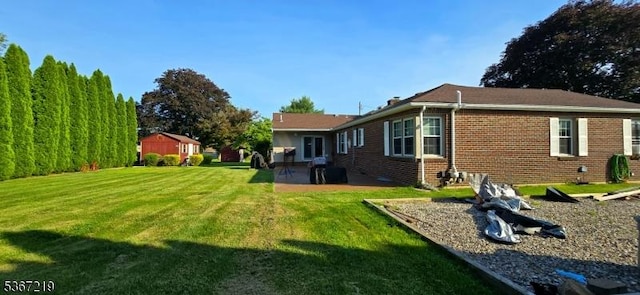 301 Ohio Ave, Pohatcong Twp, NJ 08865 - back of property with a patio area, a lawn, and brick siding