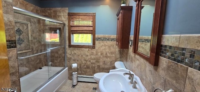 301 Ohio Ave, Pohatcong Twp, NJ 08865 - bathroom featuring a baseboard radiator, tile walls, enclosed tub / shower combo, and a wainscoted wall
