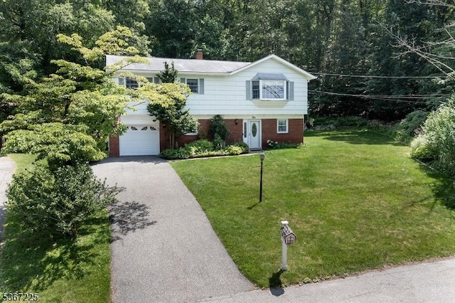 1 Lackawanna Trl, Hopatcong Boro, NJ 07843 - view of front facade with driveway, an attached garage, brick siding, a front yard, and a chimney
