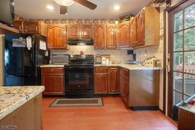 1 Lackawanna Trl, Hopatcong Boro, NJ 07843 - kitchen featuring black appliances, under cabinet range hood, ceiling fan, wood finished floors, and tasteful backsplash