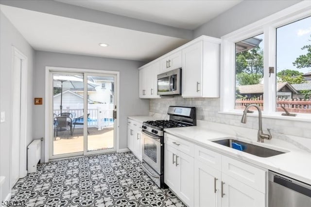 188 Wheaton Pl, Rutherford Boro, NJ 07070 - kitchen with appliances with stainless steel finishes, white cabinets, decorative backsplash, recessed lighting, and light flooring