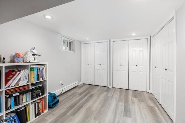 188 Wheaton Pl, Rutherford Boro, NJ 07070 - unfurnished bedroom with a baseboard radiator, wood finished floors, multiple closets, and recessed lighting