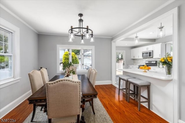 188 Wheaton Pl, Rutherford Boro, NJ 07070 - dining room with dark wood-style floors, plenty of natural light, ornamental molding, and a chandelier