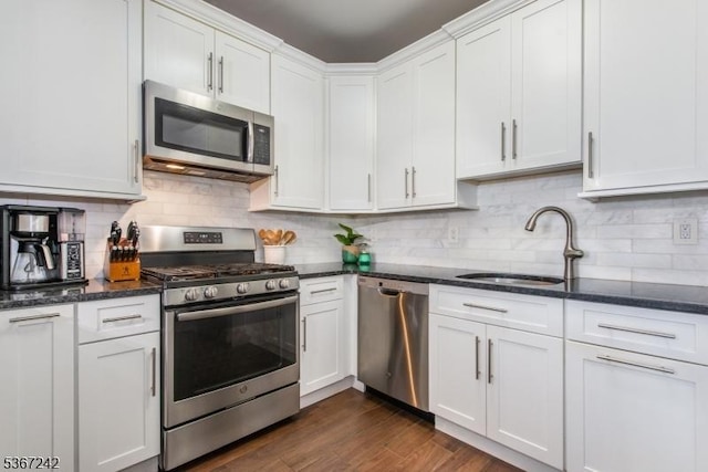 372 Cambridge Dr Unit 372, Butler Boro, NJ 07405 - kitchen with stainless steel appliances, white cabinetry, decorative backsplash, dark wood-style flooring, and dark stone counters