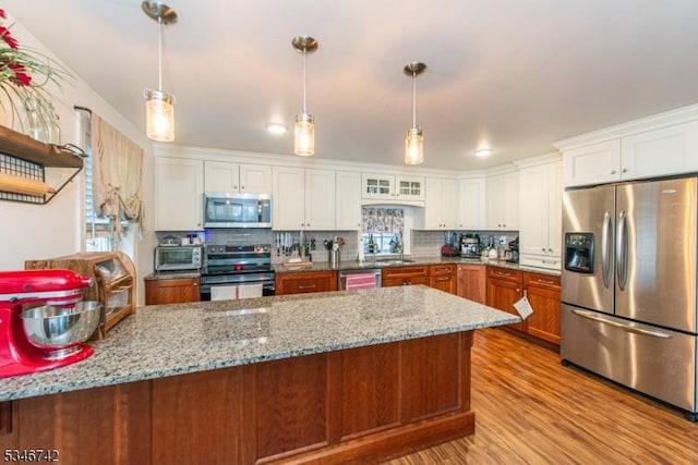 28 Middle Valley Rd, Washington Twp, NJ 07853 - kitchen featuring appliances with stainless steel finishes, light wood-type flooring, decorative backsplash, light stone counters, and white cabinets