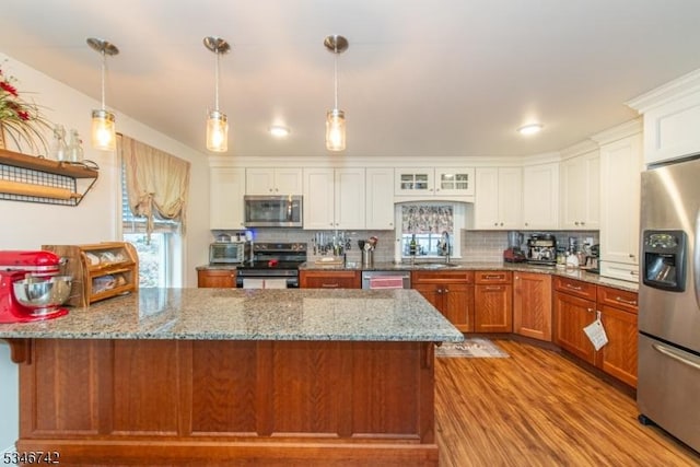 28 Middle Valley Rd, Washington Twp, NJ 07853 - kitchen featuring stainless steel appliances, healthy amount of natural light, wood finished floors, and backsplash
