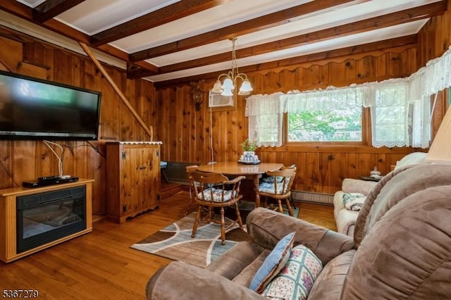 2 Hazelnut Dr, Hampton Twp, NJ 07860 - living room with a baseboard heating unit, beam ceiling, wood walls, a chandelier, and wood finished floors