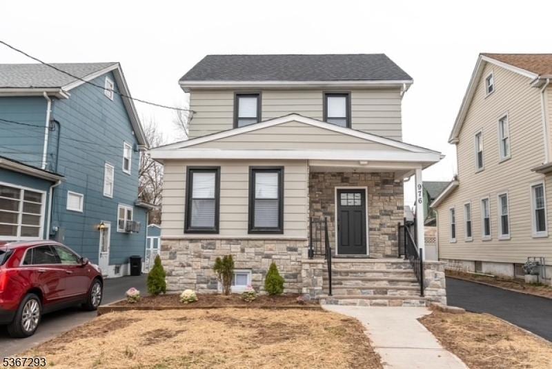 976 Potter Ave, Union Twp, NJ 07083 - traditional style home featuring stone siding, driveway, and covered porch