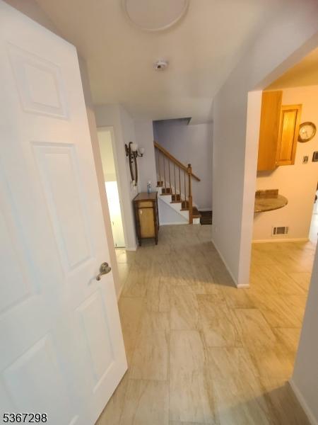 32 Berkeley Sq, Watchung Boro, NJ 07922 - hallway featuring stairway and baseboards