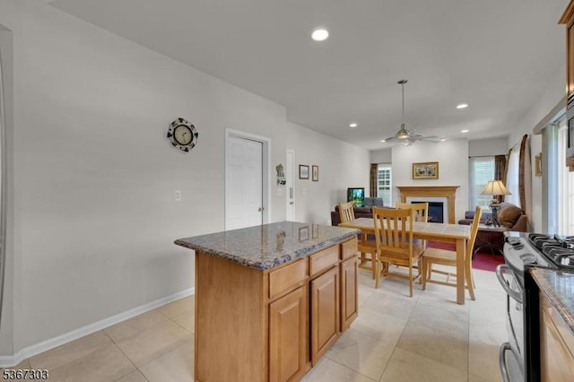 6 Bowers Dr, Allamuchy Twp, NJ 07840 - kitchen featuring appliances with stainless steel finishes, a ceiling fan, open floor plan, a fireplace, and a center island