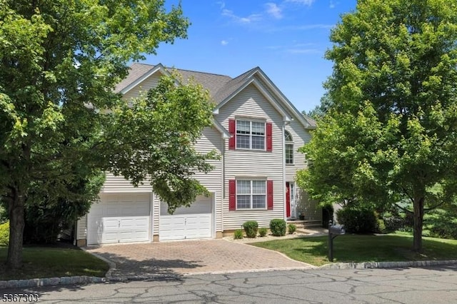 6 Bowers Dr, Allamuchy Twp, NJ 07840 - view of front facade featuring decorative driveway, an attached garage, and a front lawn