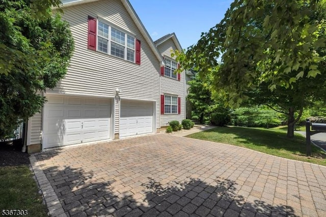 6 Bowers Dr, Allamuchy Twp, NJ 07840 - view of side of property with a garage, decorative driveway, and a lawn