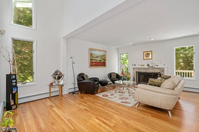 129 W Lake Shore Dr, Rockaway Twp, NJ 07866 - living room featuring a baseboard radiator, light wood-type flooring, and a fireplace