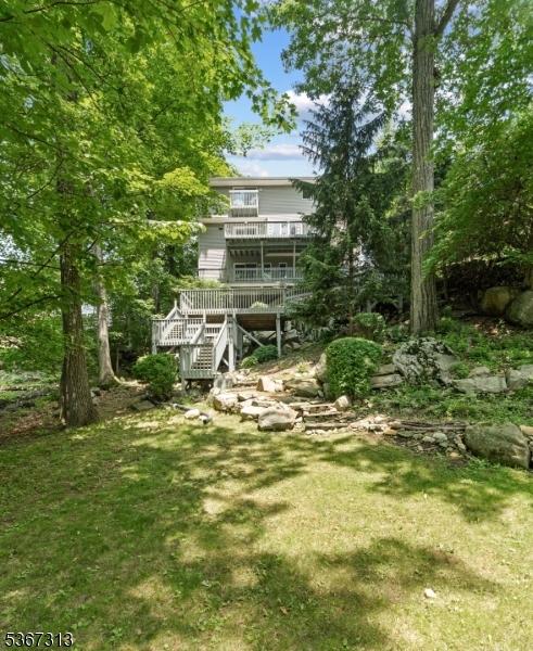 129 W Lake Shore Dr, Rockaway Twp, NJ 07866 - back of property featuring stairs, a yard, and a wooden deck