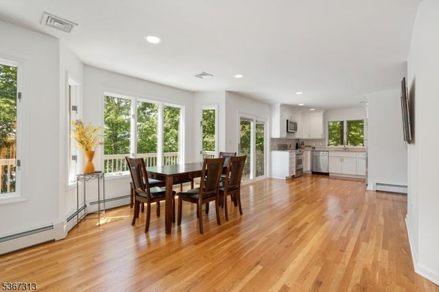 129 W Lake Shore Dr, Rockaway Twp, NJ 07866 - dining room featuring baseboard heating, light wood-style flooring, and recessed lighting