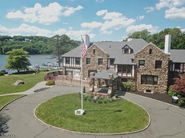 129 W Lake Shore Dr, Rockaway Twp, NJ 07866 - view of front facade featuring stone siding, a front yard, and a chimney