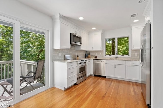 129 W Lake Shore Dr, Rockaway Twp, NJ 07866 - kitchen featuring stainless steel appliances, plenty of natural light, light wood-style flooring, backsplash, and recessed lighting
