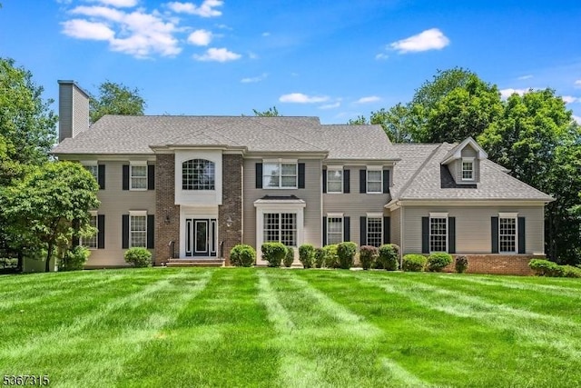 3 Mackenzie Ct, Sparta Twp, NJ 07871 - view of front of home with a front yard, brick siding, and a chimney