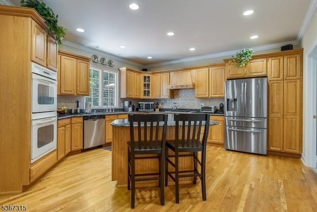 3 Mackenzie Ct, Sparta Twp, NJ 07871 - kitchen with stainless steel appliances, premium range hood, ornamental molding, dark countertops, and light wood-style flooring