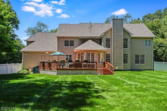 3 Mackenzie Ct, Sparta Twp, NJ 07871 - rear view of house with a fenced backyard, a deck, a chimney, and roof with shingles