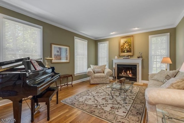 3 Mackenzie Ct, Sparta Twp, NJ 07871 - living room featuring ornamental molding, light wood-type flooring, and a glass covered fireplace