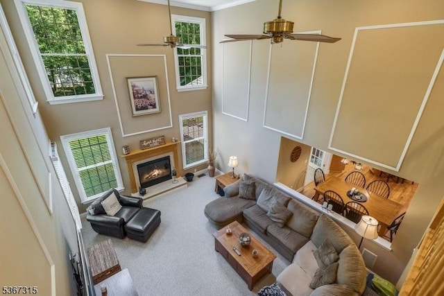 3 Mackenzie Ct, Sparta Twp, NJ 07871 - carpeted living room with ceiling fan, plenty of natural light, a towering ceiling, and a glass covered fireplace
