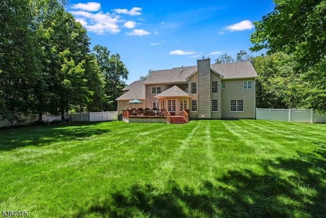 3 Mackenzie Ct, Sparta Twp, NJ 07871 - back of property featuring a deck, a fenced backyard, and a chimney