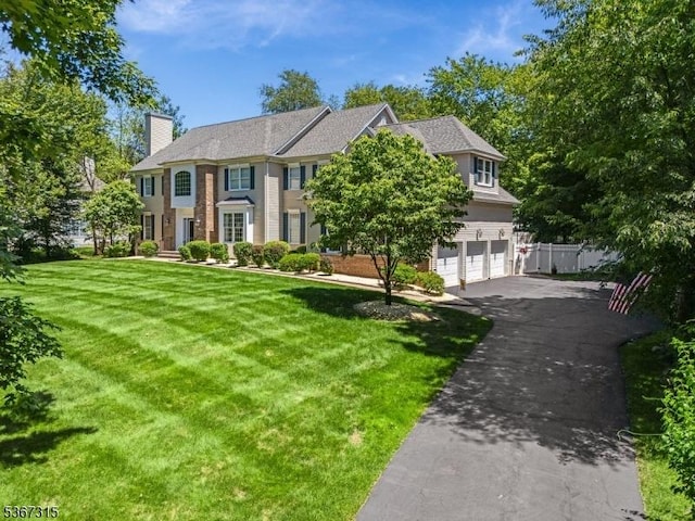 3 Mackenzie Ct, Sparta Twp, NJ 07871 - view of front of house with an attached garage, driveway, and a chimney