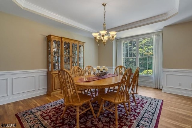 3 Mackenzie Ct, Sparta Twp, NJ 07871 - dining space with crown molding, a chandelier, a wainscoted wall, light wood-style flooring, and a raised ceiling