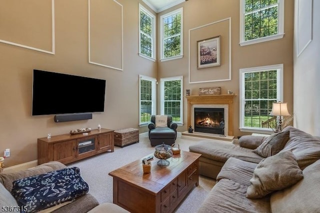 3 Mackenzie Ct, Sparta Twp, NJ 07871 - living room with a high ceiling, a warm lit fireplace, and light carpet