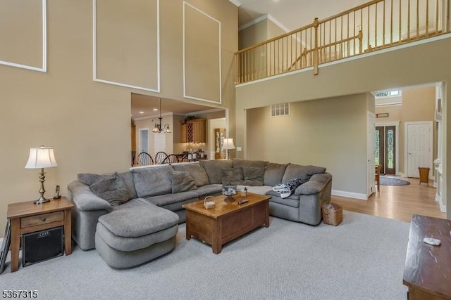 3 Mackenzie Ct, Sparta Twp, NJ 07871 - carpeted living room featuring a high ceiling, a chandelier, and wood finished floors