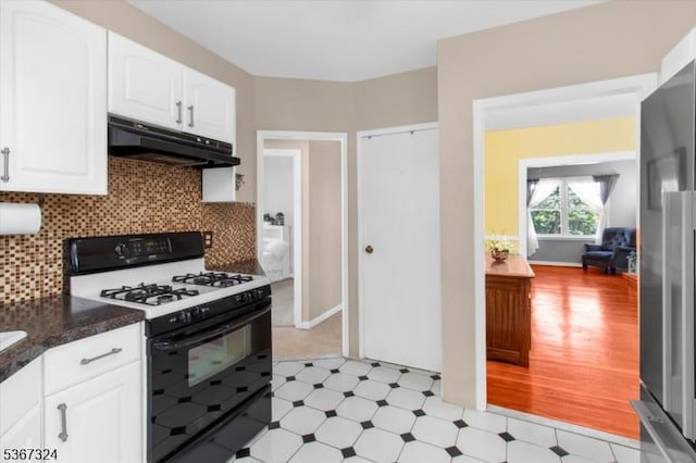 7 Park Ave, Summit City, NJ 07901 - kitchen with black gas range oven, under cabinet range hood, light floors, and white cabinets