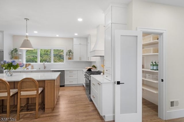 211 Spencer Rd, Bernards Twp, NJ 07920 - kitchen with stainless steel appliances, custom range hood, light countertops, light wood-style flooring, and recessed lighting