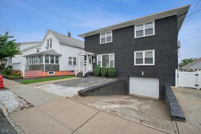 28 Sanford Ave, Belleville Twp, NJ 07109 - view of front of property with a garage, driveway, and brick siding