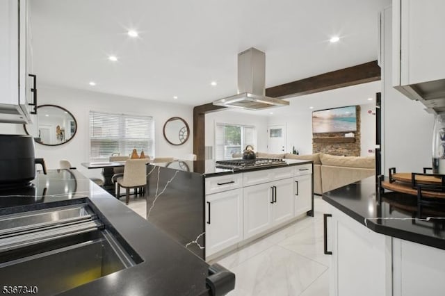 28 Sanford Ave, Belleville Twp, NJ 07109 - kitchen with island exhaust hood, stainless steel gas stovetop, dark countertops, white cabinetry, and open floor plan
