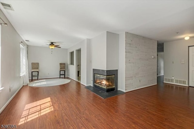 81 Village Dr Unit 81, Morris Twp, NJ 07960 - unfurnished living room featuring wood finished floors, a ceiling fan, and a multi sided fireplace